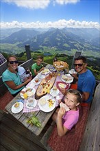Family eating a snack at the Salvenalm