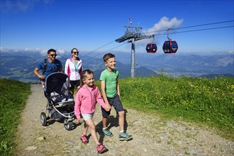 Family hiking on the summit panorama trail of the Hohe Salve