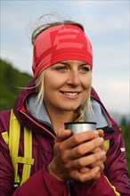 Female hiker at the tea break at Feldalphorn