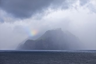 The Faroe Island Kalsoy in the Atlantic Ocean with a small piece of a rainbow