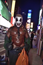 Bodybuilder gets photographed with tourists in Times Square