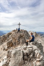 Hiker takes a break at the summit of the Birkkarspitze
