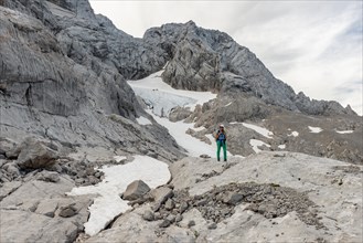 Hiker looks at alpine landscape