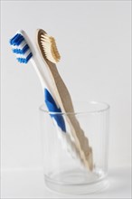 Wooden and plastic toothbrush in glabecher. Switzerland