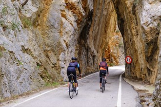 Cyclists in the rock gate sa Bretxa