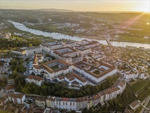 Aerial view of Coimbra with university at top of the hill at sunset
