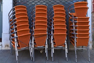 Locked stacking chairs in front of a restaurant