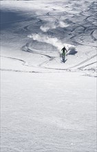 Skier with touring skis in deep snow