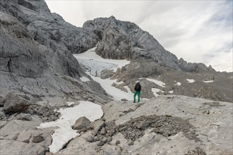 Hiker looks at alpine landscape