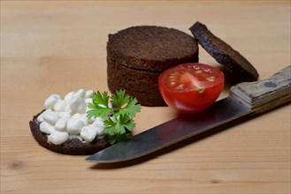 Pumpernickel disc covered with cream cheese