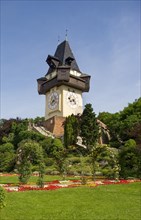 Rose garden on the Schlossberg with clock tower