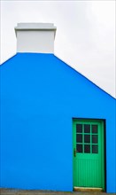 Blue house facade with green front door