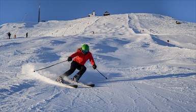 Skier descending a steep slope