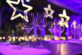 Table set for a Christmas party with wine glasses and Christmas decorations