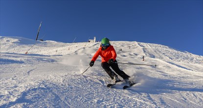 Skier descending a steep slope
