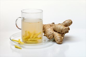 Ginger tea in glass and ginger root