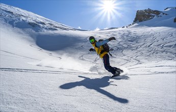 Snowboarder with splitboard rides in the snow