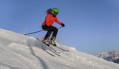 Skier jumps over humps