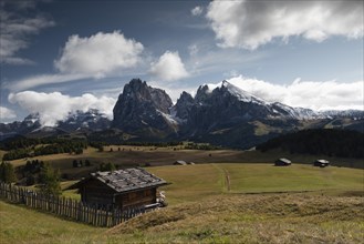 Hut in front of mountain range