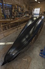Freshly lined hull of a gondola in a boatyard on the island of Guidecca