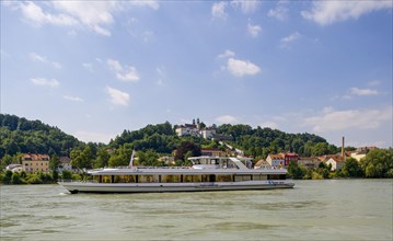 Excursion boat on the Inn with pilgrimage church Mariahilf