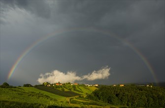 Rainbow with clouds and small village