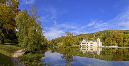 Castle Hernstein with pond with beautiful autumn colours in the park