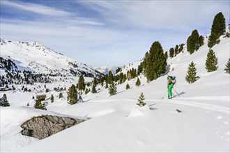 Ski tourers in a snowy mountain landscape