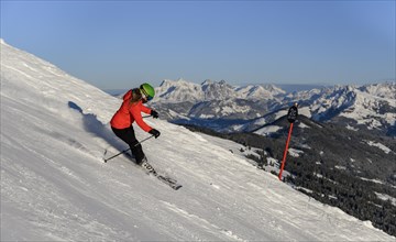Skier going down steep slope