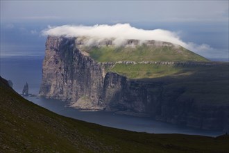 Landscape overlooking the northeast coast of Eysturoy in the North Atlantic with the stone columns Risin og Kellingin