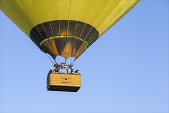 Basket of a hot-air balloon with people