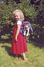 Girl with Jack Russell Terrier in her backpack