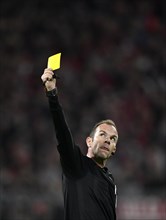Referee Marco Fritz shows yellow card