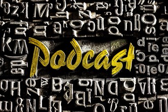Old lead letters with golden writing show the word podcast