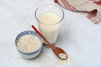 Rice milk in glass and rice grains