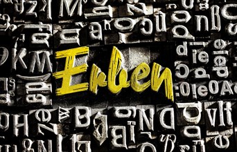 Old lead letters with golden writing show the word Erben