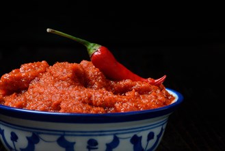 Red Thai curry paste and chili pepper in shell