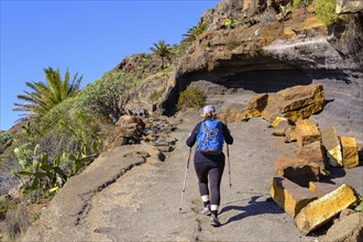 Woman hiking on rocky trail