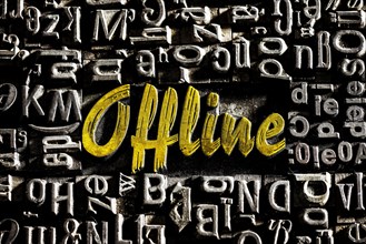 Old lead letters with golden writing show the word offline