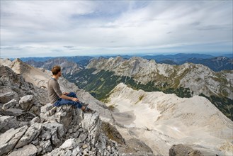 Hiker sitting at the summit of the Birkkarspitze