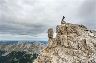 Mountaineer stands on a rock