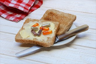 Food supplement on toast and plate with knife