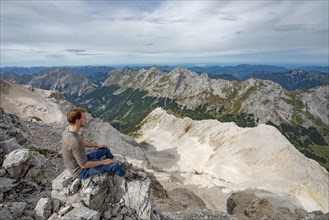 Hiker sitting at the summit of the Birkkarspitze