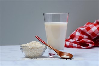 Rice milk in glass and rice grains