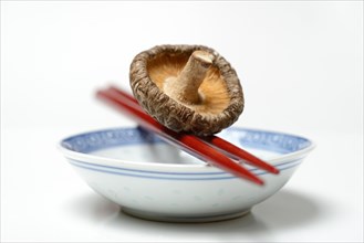 Dried shiitake on chopsticks