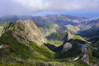 Mountains Roque de Ojila and Roque de la Zarcita with mountain road in Monumento Natural de los Roques