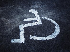 Pictogram of a disabled parking place on asphalt