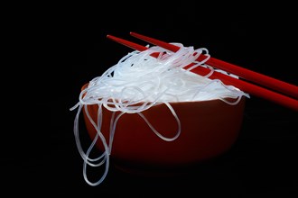 Asian glass noodles in bowl with chopsticks