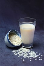 Rice milk in glass and rice grains