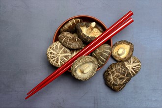 Dried shiitake mushrooms and red chopsticks